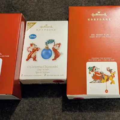 Sale Photo Thumbnail #46: Collection of four Disney-themed Hallmark Keepsake Christmas tree ornaments in their original boxes, including Nightmare Before Christmas, Chip 'n Dale, Mickey and Pluto, and Beauty and the Beast.