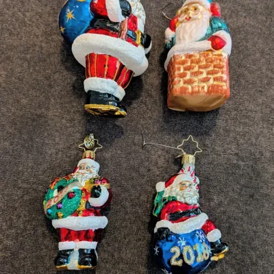 Sale Photo Thumbnail #72: Set of four Christopher Radko blown-glass Santa Christmas ornaments, featuring detailed hand-painted designs and glitter accents, including dated pieces.