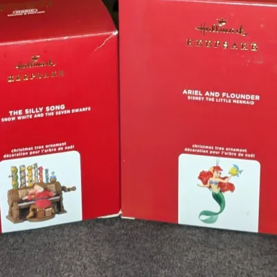 Sale Photo Thumbnail #55: Two boxed Disney Hallmark Keepsake Christmas tree ornaments, including 'The Silly Song' from Snow White and 'Ariel and Flounder' from The Little Mermaid.