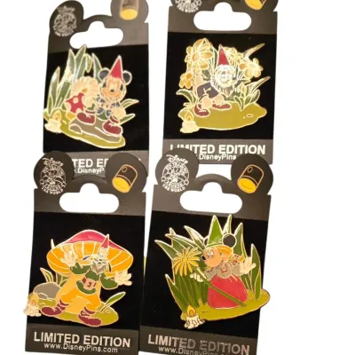 Sale Photo Thumbnail #34: Set of four Disney Pin Trading Limited Edition gnome-themed enamel pins, mounted on their original black backing cards.