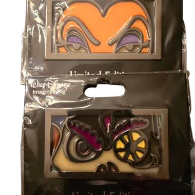 Sale Photo Thumbnail #30: Two Walt Disney Imagineering limited edition collectible enamel pins featuring Disney villain eyes, sealed in original backing card packaging.