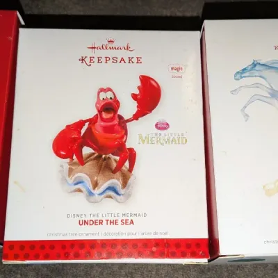 Sale Photo Thumbnail #4: Trio of Hallmark Keepsake Disney Christmas ornaments in original boxes, including Mickey Mouse Radio, Sebastian from The Little Mermaid, and Elsa and Nokk from Frozen II.