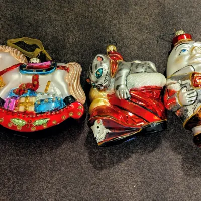 Sale Photo Thumbnail #75: Set of three vintage-style blown glass Christmas ornaments featuring a rocking horse, a cat on a sack, and Humpty Dumpty.
