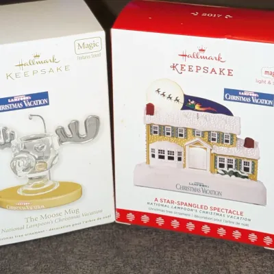 Sale Photo Thumbnail #61: Two boxed Hallmark Keepsake Christmas ornaments themed after National Lampoon's Christmas Vacation, including 'The Moose Mug' and 'A Star-Spangled Spectacle' from 2017.