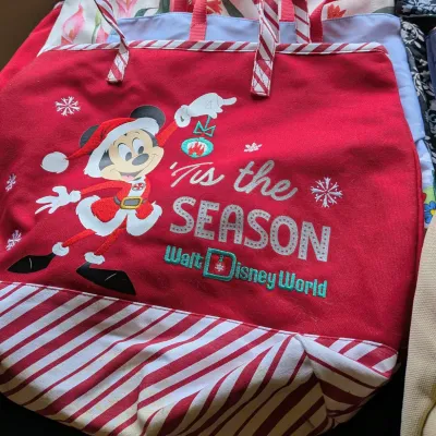 Sale Photo Thumbnail #82: Red Walt Disney World Christmas tote bag featuring Santa Mickey Mouse and red-and-white striped trim.