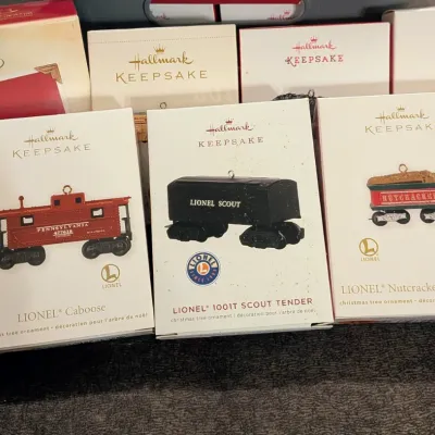 Sale Photo Thumbnail #42: Collection of boxed Hallmark Keepsake Christmas tree ornaments featuring Lionel train cars, including a Caboose, 1001T Scout Tender, and Nutcracker Route Tender.