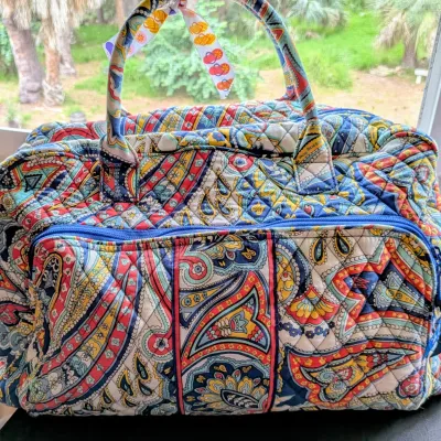Sale Photo Thumbnail #86: Vera Bradley quilted paisley duffel bag in a colorful pattern, featuring dual top handles and a front zippered pocket.