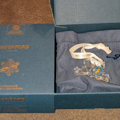 Sale Photo Thumbnail #56: Waterford Crystal mini snowflake ornament, complete with its original branded box, pouch, and ribbon.