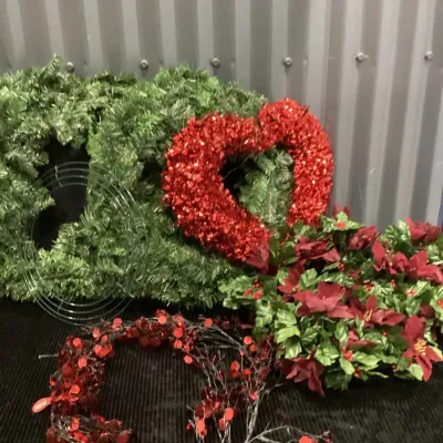 A Mixed Lot Of Artificial Holiday Wreaths, Tinsel Heart, And Floral Garland And More