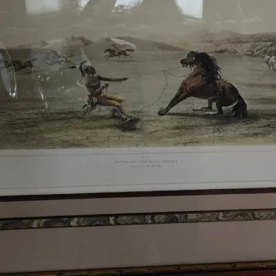 Framed George Catlin art print titled "Catching the Wild Horse", housed under glass in a decorative multi-matted wooden frame.