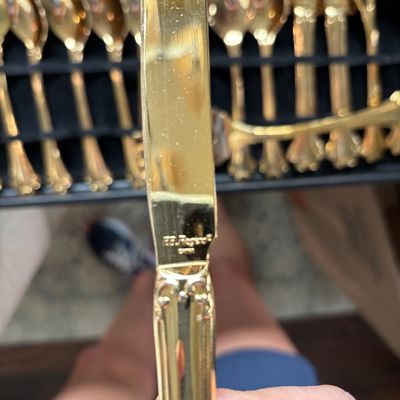 F.B. Rogers gold-plated flatware set knife closeup, showing the maker's mark at the base of the blade.