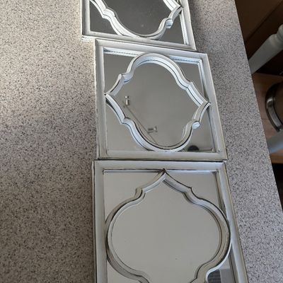Set of three square wall mirrors featuring distressed white frames with inner quatrefoil overlays in a farmhouse style.