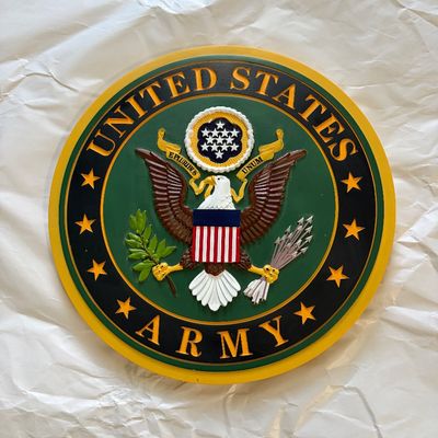 Round painted wooden United States Army wall plaque featuring a raised bald eagle emblem and stars.