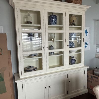 Large white off-white painted china cabinet and buffet hutch with glass display doors and solid bottom cabinets.