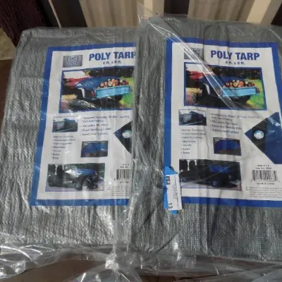 Two new-in-package Camco Tools poly tarps, measuring 6 feet by 8 feet each.