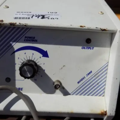 Vintage Model 2000 power control unit with probe attachment port and rotary control knob, showing surface wear and minor rust along the...