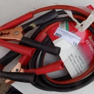 Set of 12-foot, 8-gauge booster jumper cables with heavy-duty copper-plated clamps, shown in original packaging.
