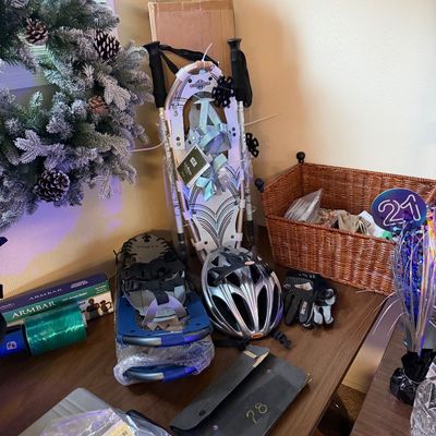 Collection of winter sports and outdoor gear featuring L.L. Bean snowshoes with trekking poles, a Bell bicycle helmet, cycling gloves,...