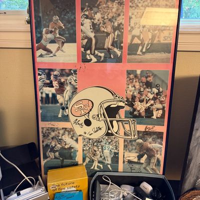 Framed vintage San Francisco 49ers sports poster featuring various player signatures and game action photos.