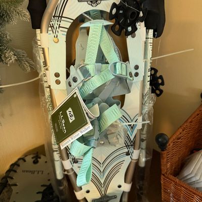 L.L. Bean Women's Winter Walker 25 snowshoes with light blue frames, adjustable bindings, and original retail tags attached.