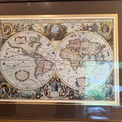 Framed reproduction print of Henricus Hondius's 1630 world map, featuring double hemisphere cartography and ornate allegorical...