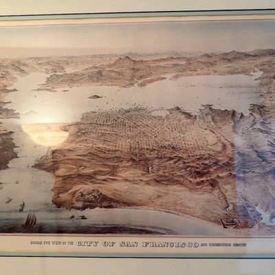 Framed antique-style print titled 'Bird's Eye View of the City of San Francisco and Surrounding Country', housed behind...