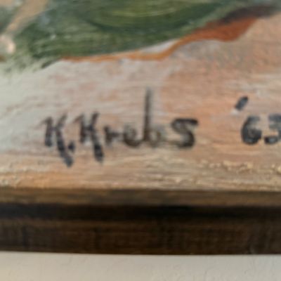 Close-up of an artist signature reading "K. Krebs '63" on a framed painting.