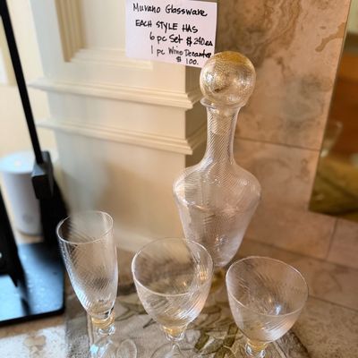 Murano blown glassware set featuring a swirl pattern with gold dust accents, including stemware and a matching stoppered decanter.