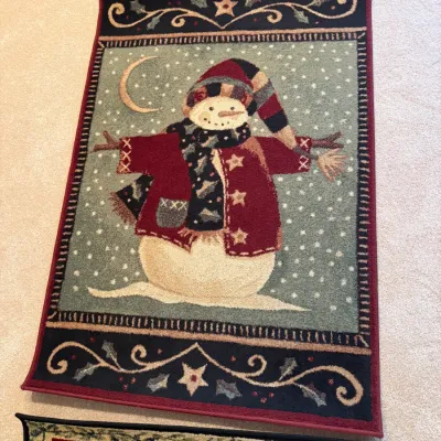 Sale Photo Thumbnail #57: Festive holiday area rug featuring a snowman design with a burgundy border, star accents, and winter motifs.