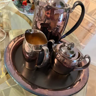 Sale Photo Thumbnail #47: Four-piece mid-century modern silver-plated coffee and tea service, including a tall coffee pot, creamer, lidded sugar bowl, and matching round tray.