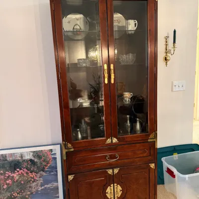 Sale Photo Thumbnail #38: Bernhardt Asian-style mahogany display cabinet featuring glass-front upper doors, brass corner hardware and pulls, a single center drawer, and lower cabinet storage.