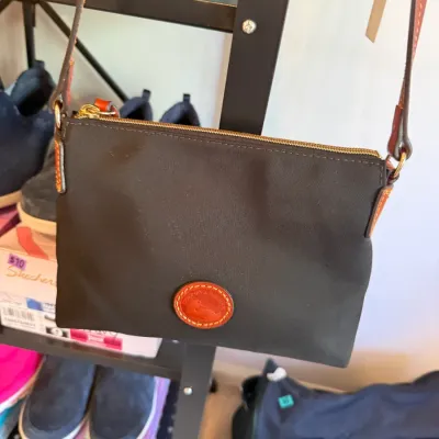 Sale Photo Thumbnail #52: Black Dooney & Bourke nylon crossbody bag with leather duck logo patch and trim.