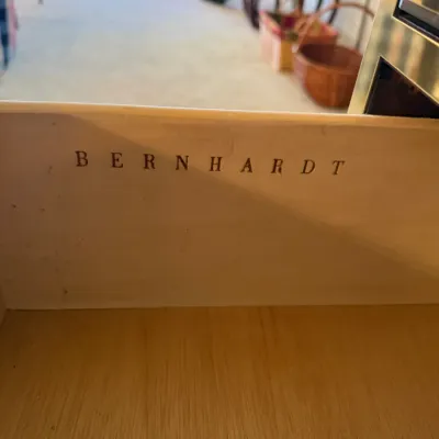 Sale Photo Thumbnail #39: Bernhardt furniture maker's mark stamped on the interior wood panel of a drawer.