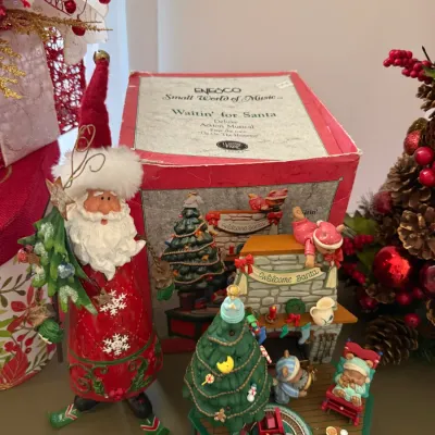 Sale Photo Thumbnail #26: Vintage Enesco "Waitin' for Santa" deluxe action musical figurine with its original box, displayed alongside a tall Santa Claus figure.