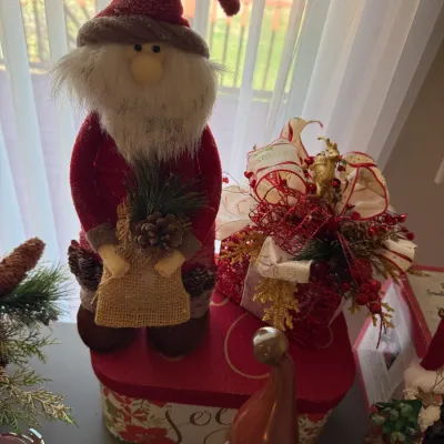 Sale Photo Thumbnail #28: Plush gnome-style Santa Claus figurine holding a burlap sack alongside glittery festive Christmas gift box decorations.