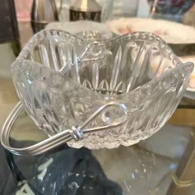 Sale Photo Thumbnail #43: Vintage pressed crystal candy dish with a scalloped edge and wire bail handle.