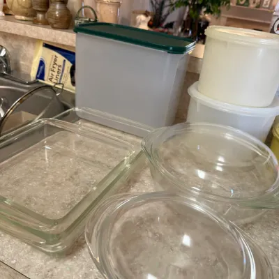 Sale Photo Thumbnail #73: Assortment of kitchenware including clear glass baking dishes with lids and plastic Tupperware-style storage containers.