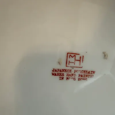 Sale Photo Thumbnail #14: Red maker's mark reading 'Japanese Porcelain Wares Hand Painted in Hong Kong' on the base of a ceramic piece.