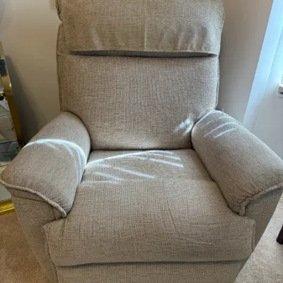 Sale Photo Thumbnail #3: Contemporary power recliner armchair in a beige textured fabric, featuring a plush high-back design and padded armrests.