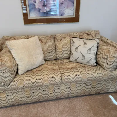 Sale Photo Thumbnail #2: Two-cushion loveseat w/ pullout bed. upholstered in a neutral flame-stitch wavy patterned fabric, paired with two throw pillows.