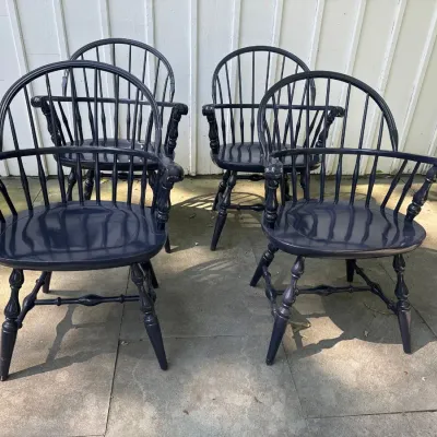 Set of four dark navy blue painted Windsor-style armchair dining chairs with spindle backs and turned legs.