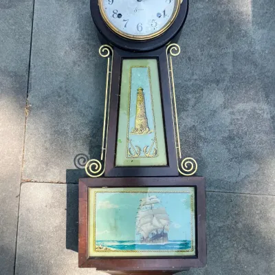Vintage Sessions banjo-style wall clock featuring a wooden case with brass filigree accents, a painted lighthouse mid-panel, and a...