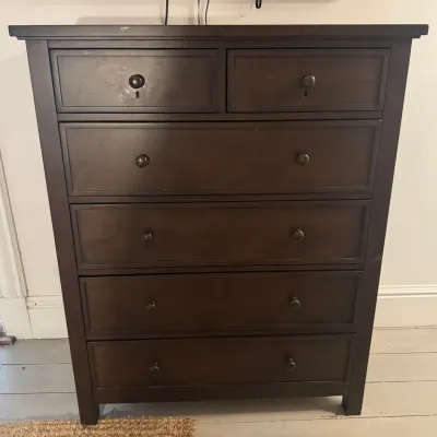 Dark espresso-finished wooden tallboy dresser with five total drawers, keyhole details on the top pair, and matching dark hardware.