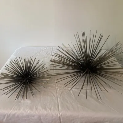 Pair of mid-century modern style metallic starburst urchin sculptures in graduating sizes.