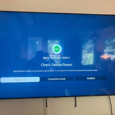 Large wall-mounted flat-screen television displaying an on-screen menu, shown in powered-on working condition.