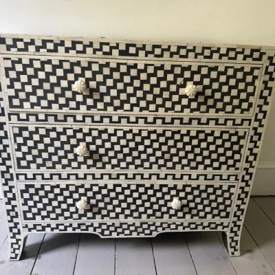Contemporary Indian-style bone inlay three-drawer chest featuring a black and white geometric checkered pattern with flower-carved knobs.