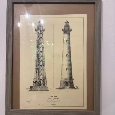 Framed architectural print displaying a cross-section blueprint of the 1849 Cape Hatteras, N.C. First Order Lighthouse, housed in a grey...