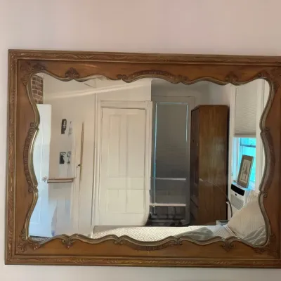 Large French Provincial style wall mirror featuring a carved wooden rectangular frame with a decorative inner scalloped border.