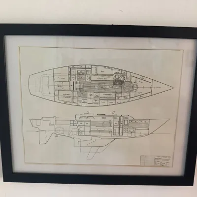 Framed sailboat blueprint schematics by Henry R. Hinckley & Co. in a simple black frame with white matting.