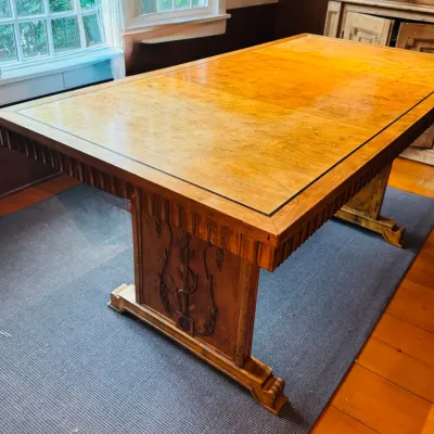 Sale Photo Thumbnail #39: Vintage Art Deco style burl wood dining table featuring a decorative inlaid tabletop border and carved relief details on the pedestal base.
